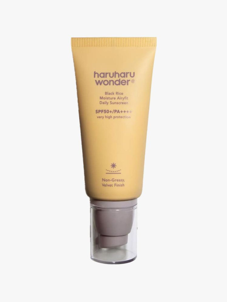 A yellow tuve of Haruharu Wonder Black Rice Moisture Airyfit Daily Sunscreen on a light gray background